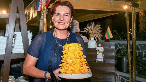 Lithuanian Ambassador Diana Mickeviciene poses with a 3d print of a Šakotis, a traditional spit cake