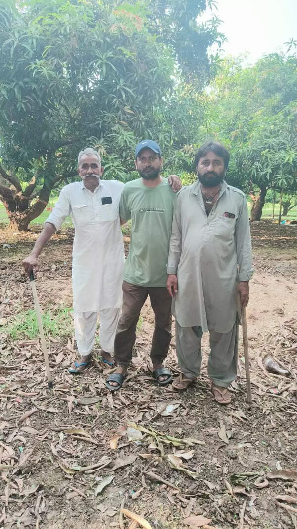 Aakash Desai (centre) with guards from the Pathan community at his mango farm in Valsad.