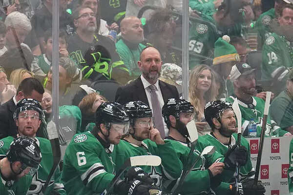 Pete DeBoer watches the action from behind the bench