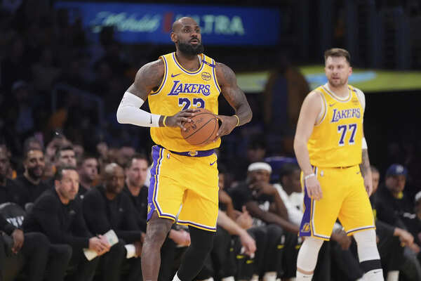 Los Angeles Lakers Forward Lebrou James, Left, Passes AS Teammate Guard Luka Doncic Looks on During the First Half of An NBA Basketball Game Against the Utah Jazz, Monday, Feb. 10, 2025, in Los Angeles. (Image via AP Photo/Mark J. Terrill) Lebron James and Luka Doncic