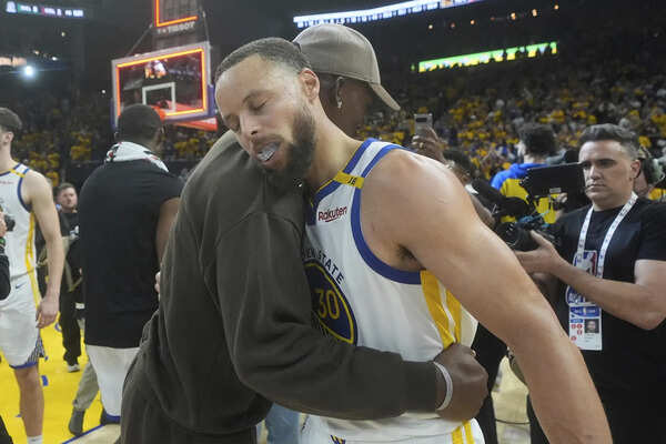 Golden State Warriors guard Stephen Curry, foreground, celebrates with injured forward Jimmy Butler III after Game 3 of an NBA basketball first-round playoff series against the Houston Rockets in San Francisco, Saturday, April 26, 2025. (AP Photo/Jeff Chiu) Butler returns from 1-game absence to play for Warriors in Game 4 of playoff series against Rockets
