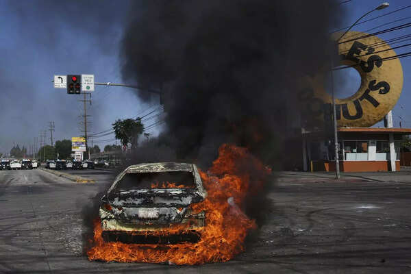 A car burns during a protest in Compton, Calif., Saturday, June 7, 2025, after federal immigration authorities conducted operations. (AP photo) Protest (3).