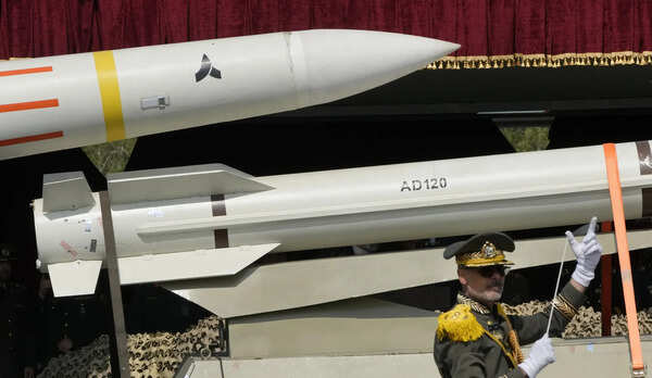 File - Missiles are taken to a truck as an Iranian Army band leader operated the music band during the Army Day parade at a military base on North Tehran, Iran, Wednesday, April 17, 2024. (AP Photo/Wahid Salemy, File) Israel and Iran: How do they compare military?