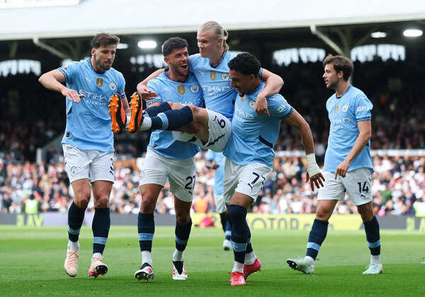Erling Haaland of Manchester City celebrates scoring his team's second goal from the penalty spot with teammates Ruben Dias, Matheus Nunes and Omar Marmoush during the Premier League match against Fulham. (Getty Images) Fulham FC v Manchester City FC - Premier League