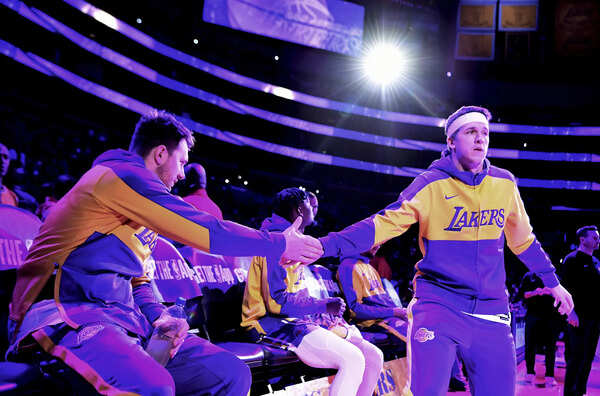 Los Angeles Lakers guard Luka Doncic, left, greets teammate Austin Reaves before an NBA basketball game with the Phoenix Suns, Sunday, March 16, 2025, in Los Angeles. (Image via AP Photo/Wally Skalij) Luka Doncic and Austin Reaves