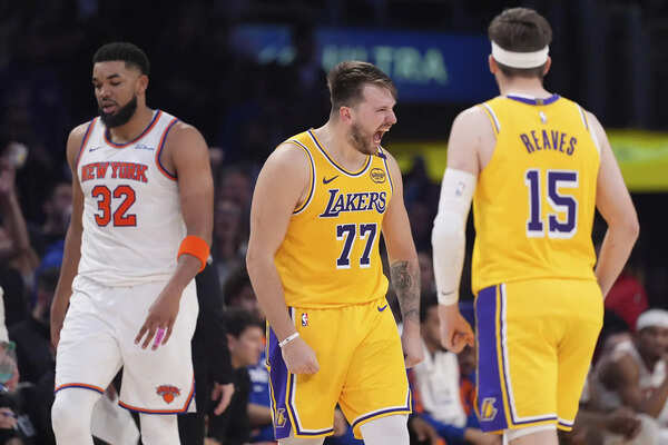Los Angeles Lakers guard Luka Doncic, center, celebrates after scoring as New York Knicks center Karl-Anthony Towns, left, walks away and guard Austin Reaves stands by during the second half of an NBA basketball game Thursday, March 6, 2025, in Los Angeles. (Imagr via AP Photo/Mark J. Terrill) Luka Doncic and Austin Reaves