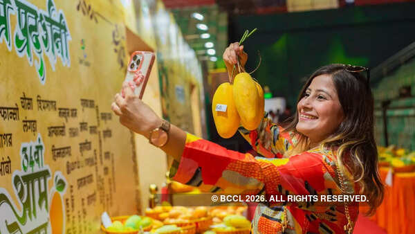 With mangoes in one hand, a visitor is all smiles as she clicks a selfie at the festival