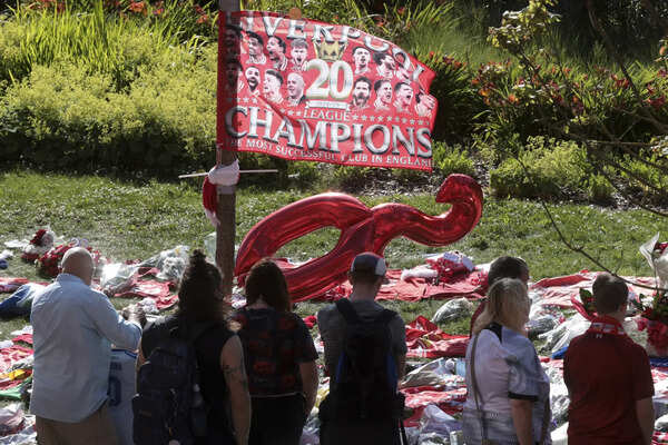 Liverpool player at football fan Enfield stands near tribute in memory of Dogo Jota. (AP) Britain Liverpool Jota Soccer