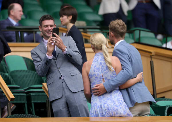 James Anderson takes a photo of Joe Root and Carrie Root in the Royal Box prior to the Gentlemen's Singles fourth round match between Alex De Minaur and Novak Djokovic (Image by Julian Finney/Getty Images) James Anderson and Joe Root