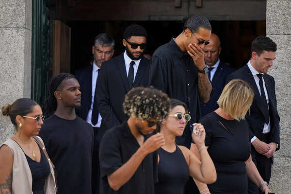Mourners including Liverpool players Andrew Robertson, Virgil van Dijk and Joe Gomez react as the coffins of Diogo Jota and his brother André Silva are carried outside the church during their funeral in Gondomar, near Porto, Portugal. (AP) APTOPIX Portugal Jota Funeral