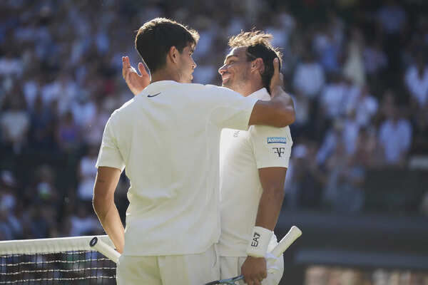 Carlos Alcaraz greets Fabio Fognini of Italy at the net after winning their first round men's singles match at the Wimbledon Tennis Championships in London (Image via AP/Alastair Grant) Fabio Fognini and Carlos Alcaraz
