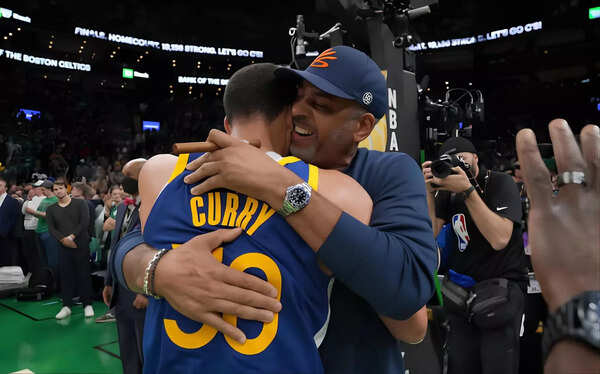 The Curry men embracing