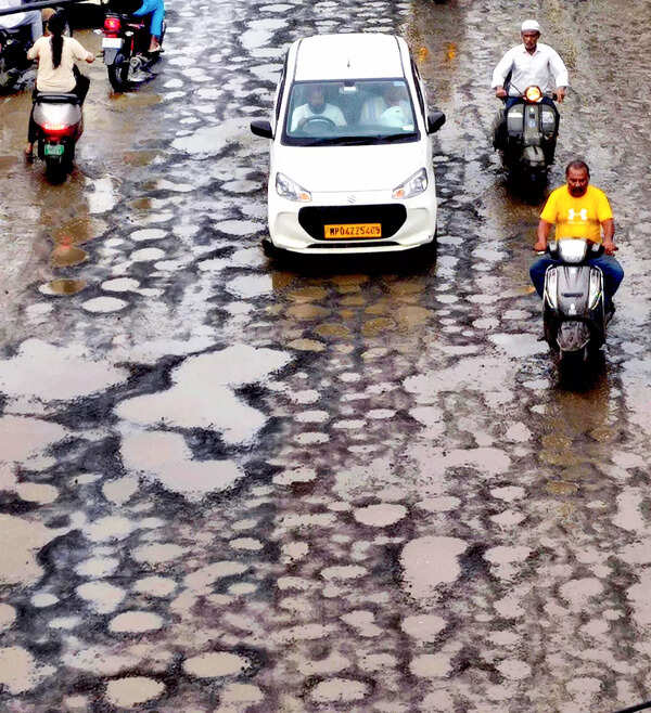 Bhopal, Jul 05 (ANI): Vehicles run on a potholed road near Bharat Talkies, in Bh...