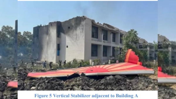 The vertical stabilizer (fig. 5) separated from the aft fuselage and came to rest about 200 feet south of the initial point of contact with the Building A. The tail section and the RH Main Landing Gear (MLG) of the aircraft were found embedded in the northeast wall of the Building A while the rest of the airplane continued its forward movement. (Image credit: Preliminary Report AAIB) (Image credit: Preliminary Report AAIB)