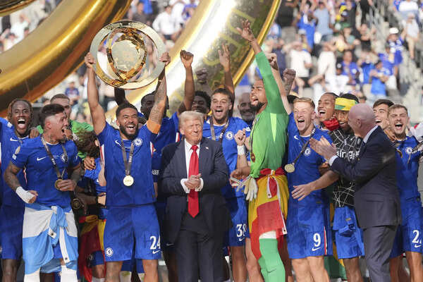 Chelsea's Reece James (24) lifts the trophy as President Donald Trump looks on following the Club World Cup final soccer match between Chelsea and PSG in East Rutherford, N.J., Sunday, July 13, 2025. (AP Photo/Seth Wenig) Chelsea beats PSG 3-0 for Club World Cup title as Palmer scores twice and sets up third goal