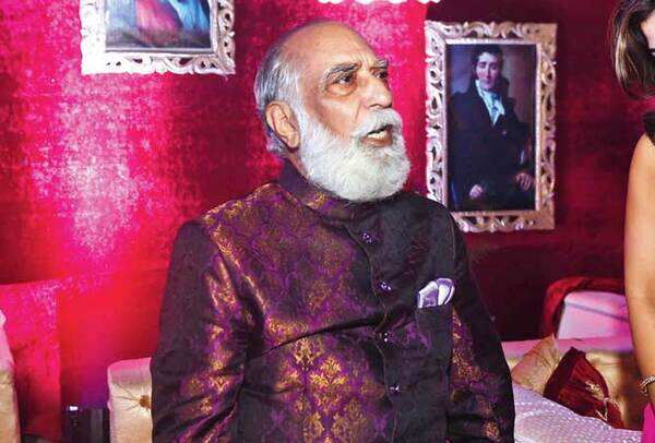 Maharana Arvind Singh Mewar sitting in front of a wall specially done up for the occasion to give the venue an authentic feel of a chateau