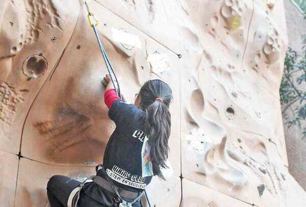 Another student climbs up the wall at the Championship (BCCL)
