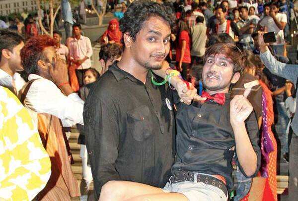 Daksh strikes a pose in his friend's arms