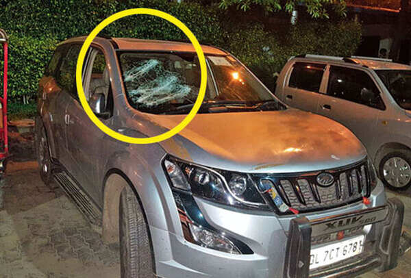 The damaged car of Parvinder’s at his residence in Noida