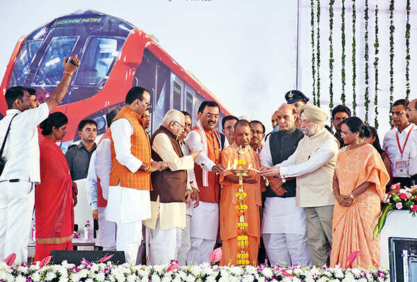 (L-R) Brajesh Pathak, Ram Naik, Keshav Prasad Maurya, Yogi Adityanath, Rajnath Singh, Hardeep Singh Puri and Rita Bahuguna Joshi lighting the inaugural lamp at the Lucknow Metro launch (BCCL/ Farhan Ahmad Siddiqui, Aditya Yadav and Vishnu Jaiswal)