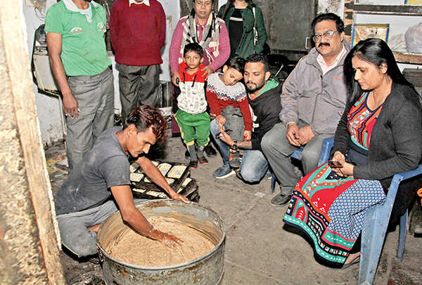 Families come together for traditional cake baking during Christmas. Here, the lady of the house watches as the ingredients are mixed for their Christmas cake at a local bhatti-wali bakery (BCCL/ Aditya Yadav)