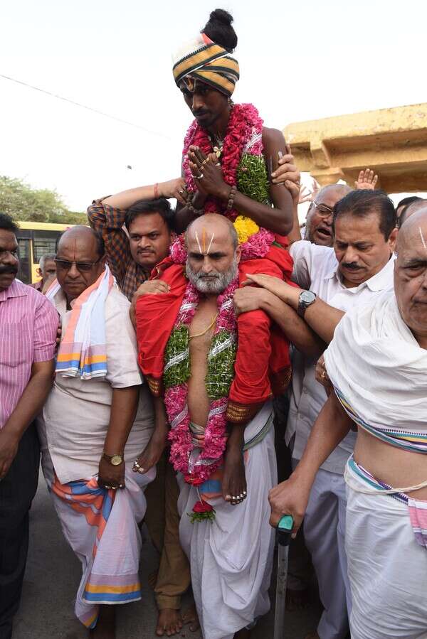 Aditya being carried into Chilkur Balaji temple after he was previously denied entry into a Hanuman Temple