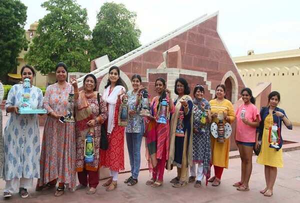 Women artists posing with their lanterns at Jantar Mantar