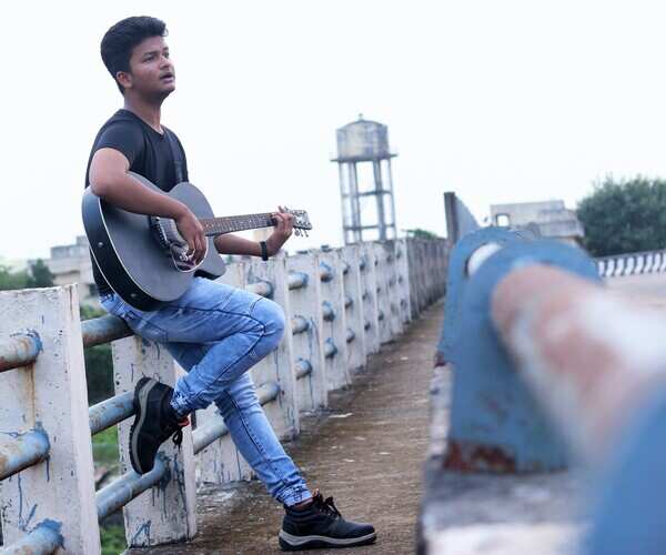 Wasim playing guitar on an overbridge