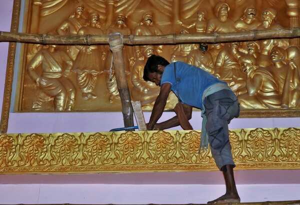 An artist busy working at Nayapalli puja mandap