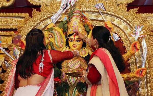 Bidding farewell to the goddess with sindoor, sweets and fond memories
