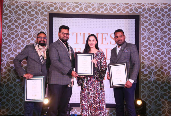 Restrurateurs of the Year Miss India UK 2012 Deana Uppal gives away the award to (L-R) Kushal Sushil, Sankalp Gupta and Raunak Khandelwal of Nibs Cafe & Chocolataria