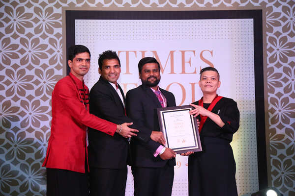 Best Chinese (Premium) House OF Han Sandeep Kumar, Virendra Prakash and Chef Lee Tuck receive the award from archer Rajat Chauhan