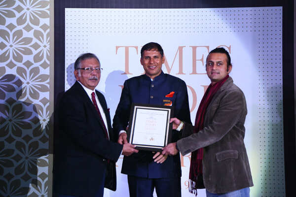 Best South Indian (Casual) Decked Up By Garden Cafe- Deepak (L) and Dinar Nowlakha receive the award from Javelin thrower Devendra Jhajharia