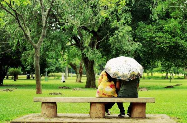 a couple enjoying rain at a park - Copy