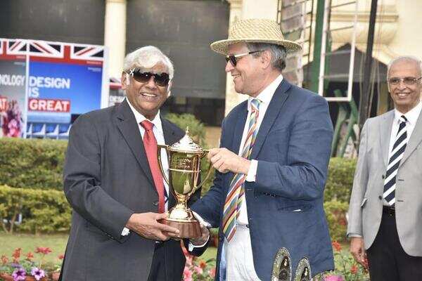 Subir Ranjan Dasgupta, owner of the winning horse Shivansh, recieves the cup from British Deputy High Commissioner Bruce Bucknell.