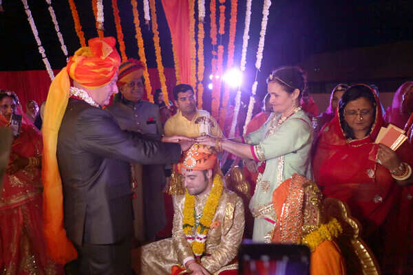Father and mother of the groom Eric and Sylvia Semey bless Sam in accordance to Hindu rituals
