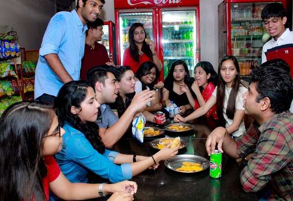 Students enjoying food in a college canteen - Copy
