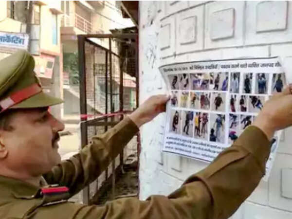 Police man sticks posters PTI