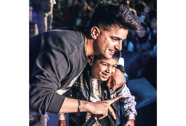 Manak hugging a young fan