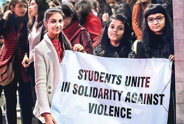 Students holding a banner with the fest's tagline written on it