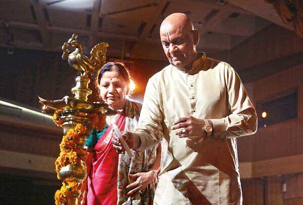Radha and Raja Reddy lighting a lamp