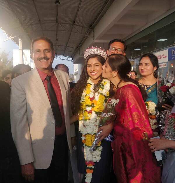 Airport welcome at Jabalpur. Father Rajesh Choudhary was proud of her while mother Rita plants a peck on her cheek with love