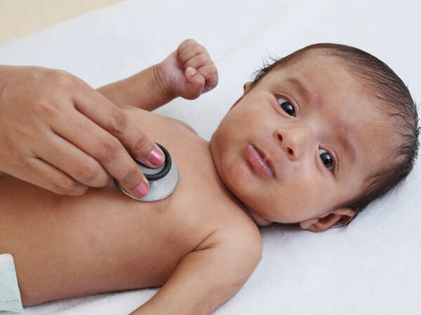 doctor examines baby with stethescope