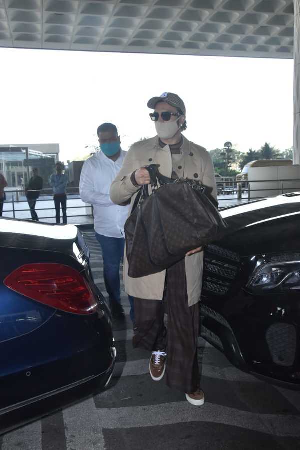 Deepika Padukone in a Louis Vuitton sweatsuit airport-style