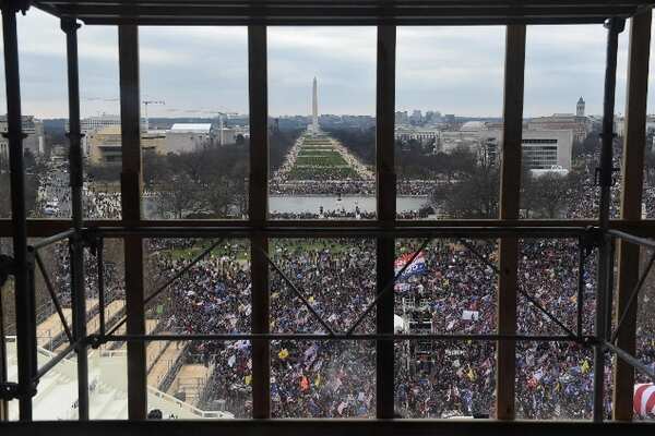 Supporters of US President Donald Trump are seen from behind scaffolding AFP 635