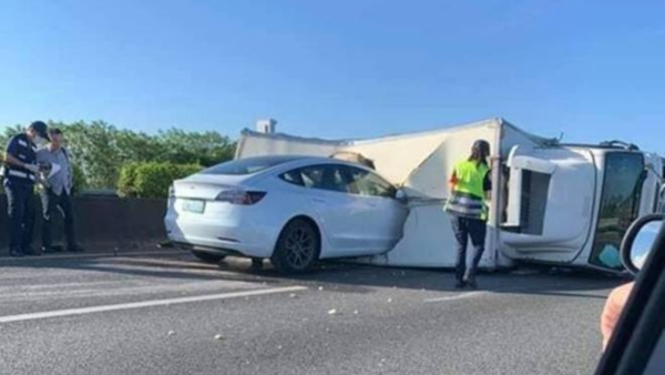 Tesla rams into crashed truck