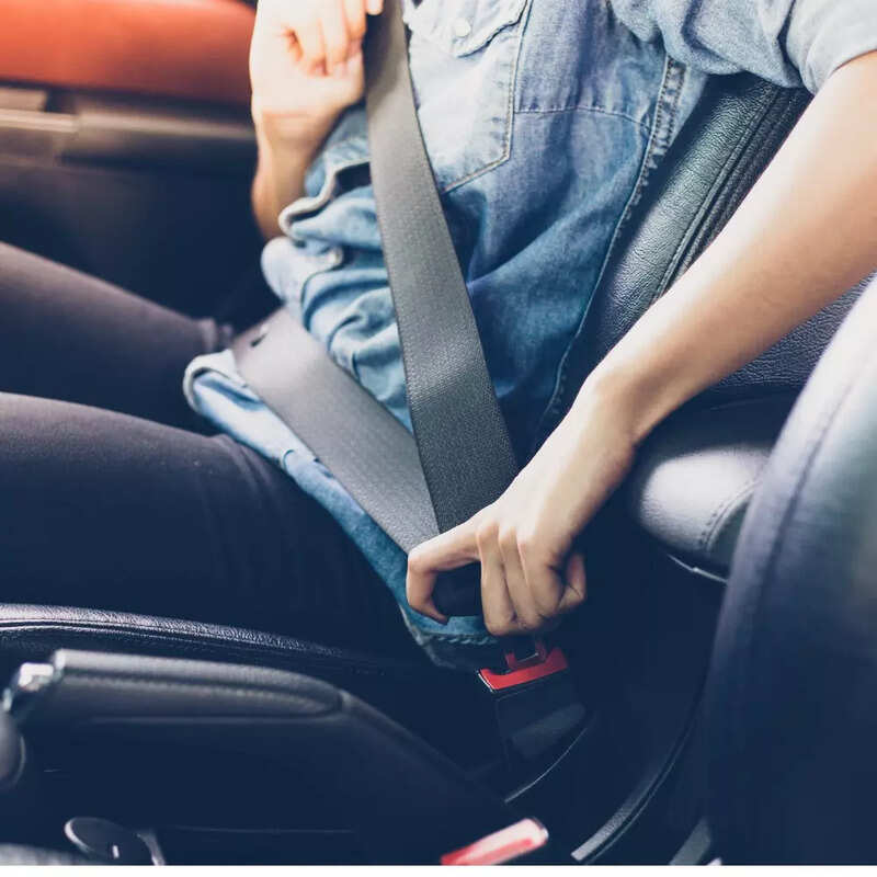 asian-woman-fastening-seat-belt-in-the-car-safety-concept-picture-id943262870