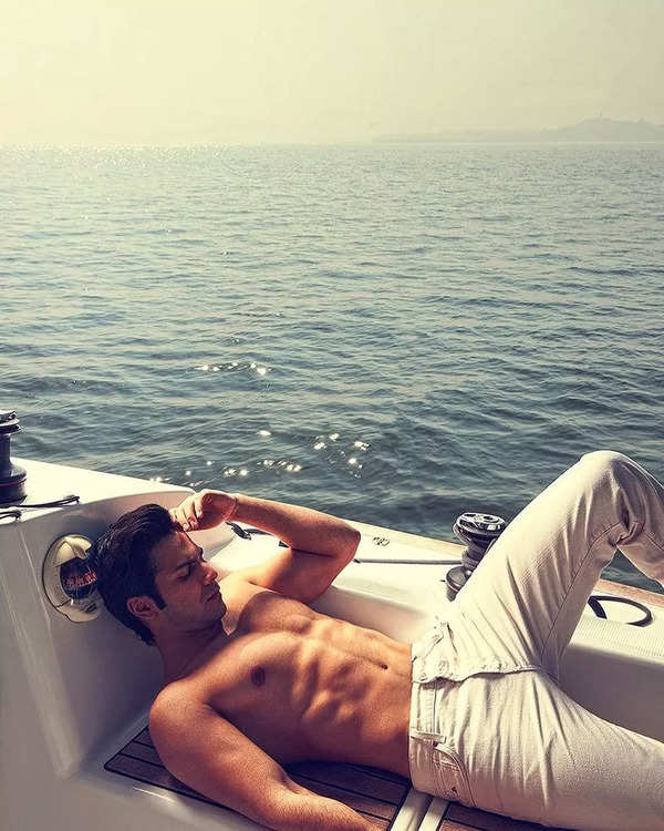 Varun Dhawan shows off his washboard abs as he poses on a yacht ...