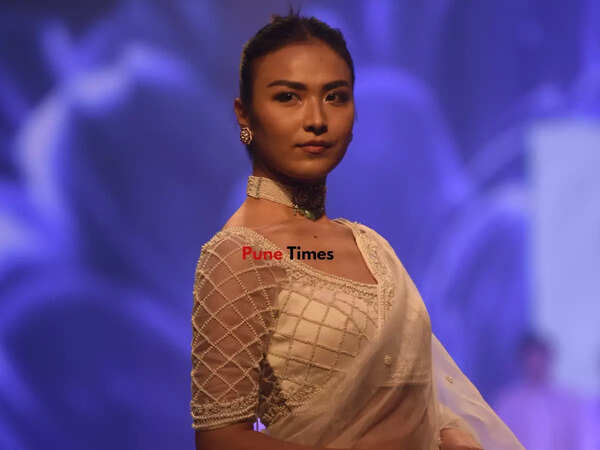 A model dons an elegant sari by Sanjev Marwaah on day 2 of Pune Times Fashion Week 2022