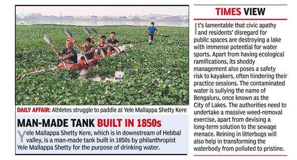 Kayakers practise in lakefilled with weeds, sewage